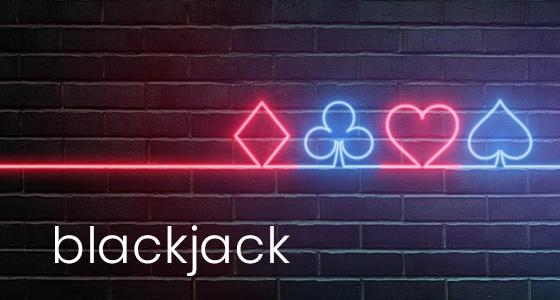 Neon diamond, club, heart and spade card symbols on a brick background