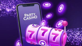 Mobile device with the Party casino app logo displayed on screen and a 777 pink slot machine in front of it on a black background with bright purple neon star chips in midair