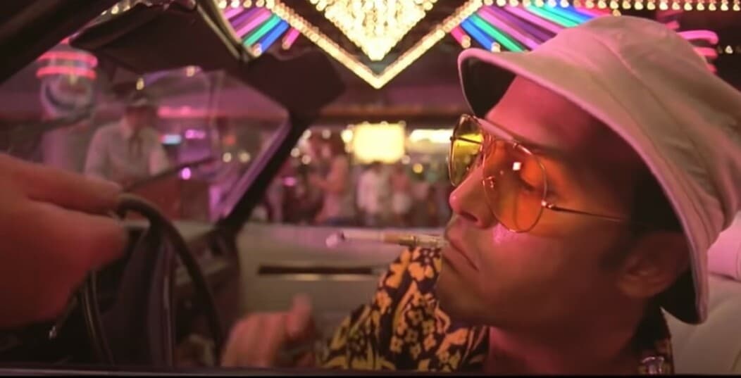 Fear and loathing in Las Vegas casino movie scene with actor Johnny Depp smoking a cigar in a car in front of a Las Vegas casino