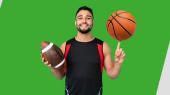 Unibet sportsbook NJ male representative holding a football and basketball in both hands and smiling, on a green and white background