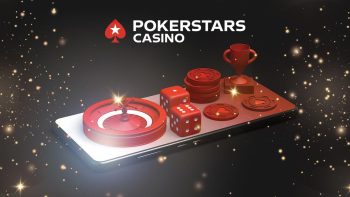 A roulette, dices, pokerchips and a small throphy arranged on a mobile phone facing up, on a black background featuring sparkles and the PokerStars Casino logo