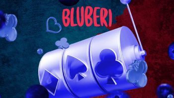 slot reel playing card suits under the Bluberi logo, on a red and blue background featuring floating blueberries and card suits
