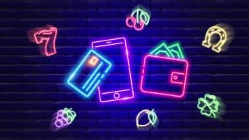 Neon wallet with money coming out of it, mobile phone, credit card surrounded by neon slots symbols flying mid air on a brick and blue background