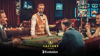 Caesars Casino and Evolution logos a photo featuring players in a physical casino room